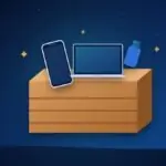 Wooden crate filled with a phone, a laptop and a USB stick, with sparkles