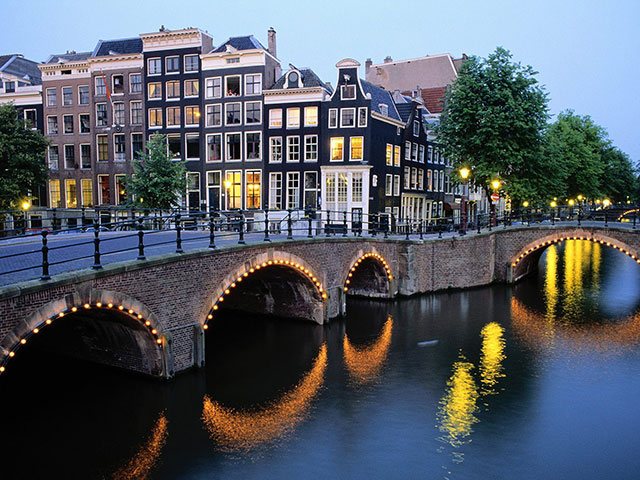 travel to the city of Amsterdam in the Netherlands, Holland and visit wonderful bridges and water canals