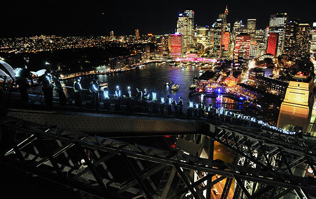 tourist enjoy view from bridge climbing at night