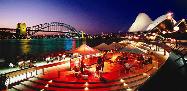 Sydney habor and the opera house in front of Sydney's skyline at night life