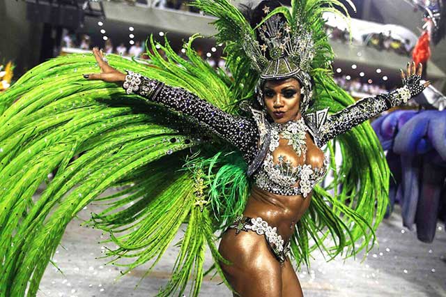 Brazilian carneval in Rio de Janeiro celebrating people on the streets with sexy dancers everywhere around tourist guide Brazil