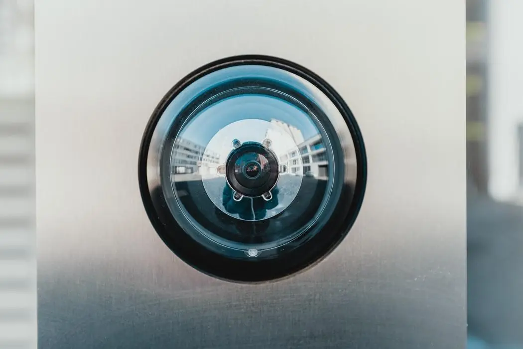 Door camera lens in a stainless steel panel