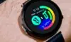 Translucent smartwatch on a minimalist wrist, matte black band, crystal‑clear display, floating holographic interface with crisp icons and data streams, illuminated by subtle blue light, showcasing sustainable, energy‑harvesting wearable design.