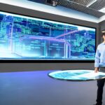 A futuristic control room with blue ambient light shows an engineer interacting with holographic server models, illustrating secure AI infrastructure governance.