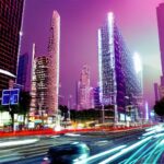 A futuristic smart city street at night where autonomous vehicles, hovering drones, and holographic ads showcase the vibrant integration of 6G connectivity and AI in daily life.