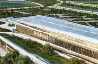 A photorealistic wide shot of a modern technology campus under construction in rural West Virginia, featuring sleek glass buildings surrounded by green fields with cinematic golden hour lighting.