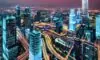 Neon‑lit futuristic city at dusk with towering skyscrapers, holographic ads, drones, and translucent data streams. A diverse group in cyberpunk attire interacts with floating holographic interfaces, reflecting awe. The scene blends physical and di…