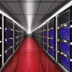 Rows of blinking server drives glow under red emergency lights as holographic data streams float through a dusty, high-contrast room, illustrating the urgent vulnerability of digital infrastructure to advanced AI threats.