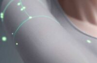Close-up of seamless smart clothing with subtle, glowing circuit patterns, illustrating integrated, passive health monitoring technology.