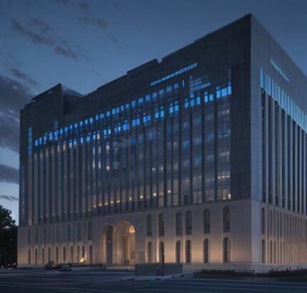 A cinematic shot of a modern government building in Washington D.C. at dusk, featuring holographic data streams and glowing blue circuit patterns overlaid on the stone architecture to symbolize the integration of AI and governance.