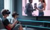 A futuristic living room where a family uses VR, gaming consoles, and video calls simultaneously, connected by golden data streams from a glowing Wi-Fi 7 router.