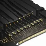 A cinematic close-up of a modern DDR5 RAM stick with a matte black heat spreader and gold-plated pins, highlighting its advanced hardware design.
