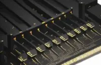 A cinematic close-up of a modern DDR5 RAM stick with a matte black heat spreader and gold-plated pins, highlighting its advanced hardware design.